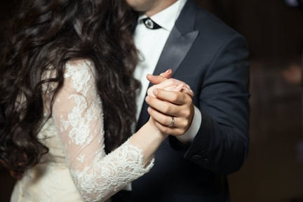 Picture of couple dancing with their hands clasped 
