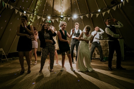 Picture of bride and wedding party goofing off on the dancefloor