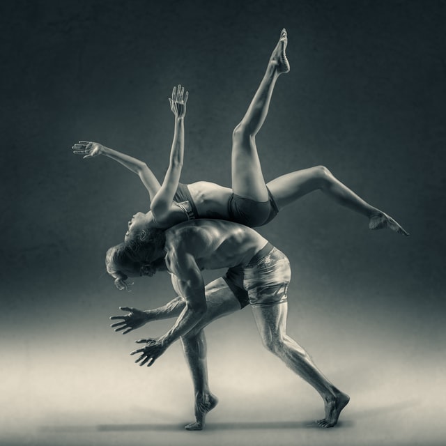 Two contemporary dancers performing together.