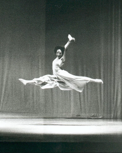 Black and white picture of modern dancer leaping, in New York City