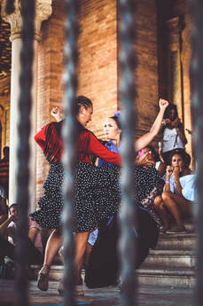 Two women dancing flamenco together outside